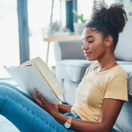 Person sitting reading a book about AI
