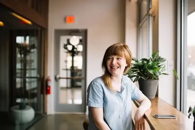 Woman sitting and smiling