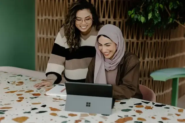 Two women looking at laptop