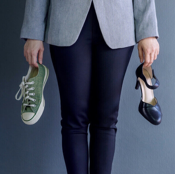 Employee holding two types of shoes