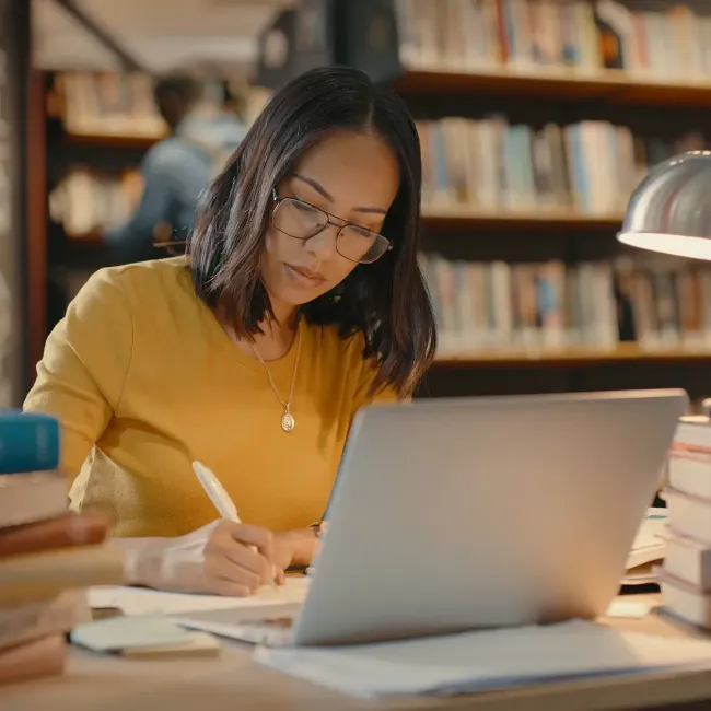 A woman researching in a library.