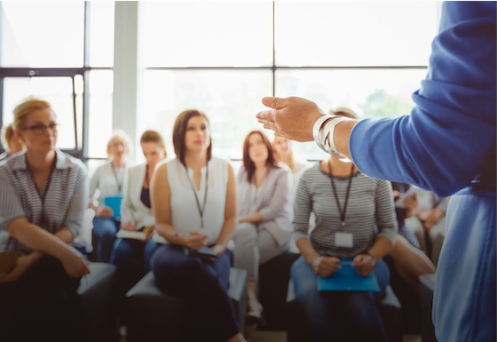 Presenter speaking at a team meeting