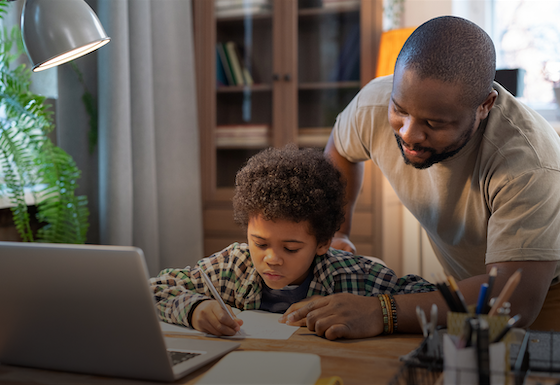 Father and son working on homework together