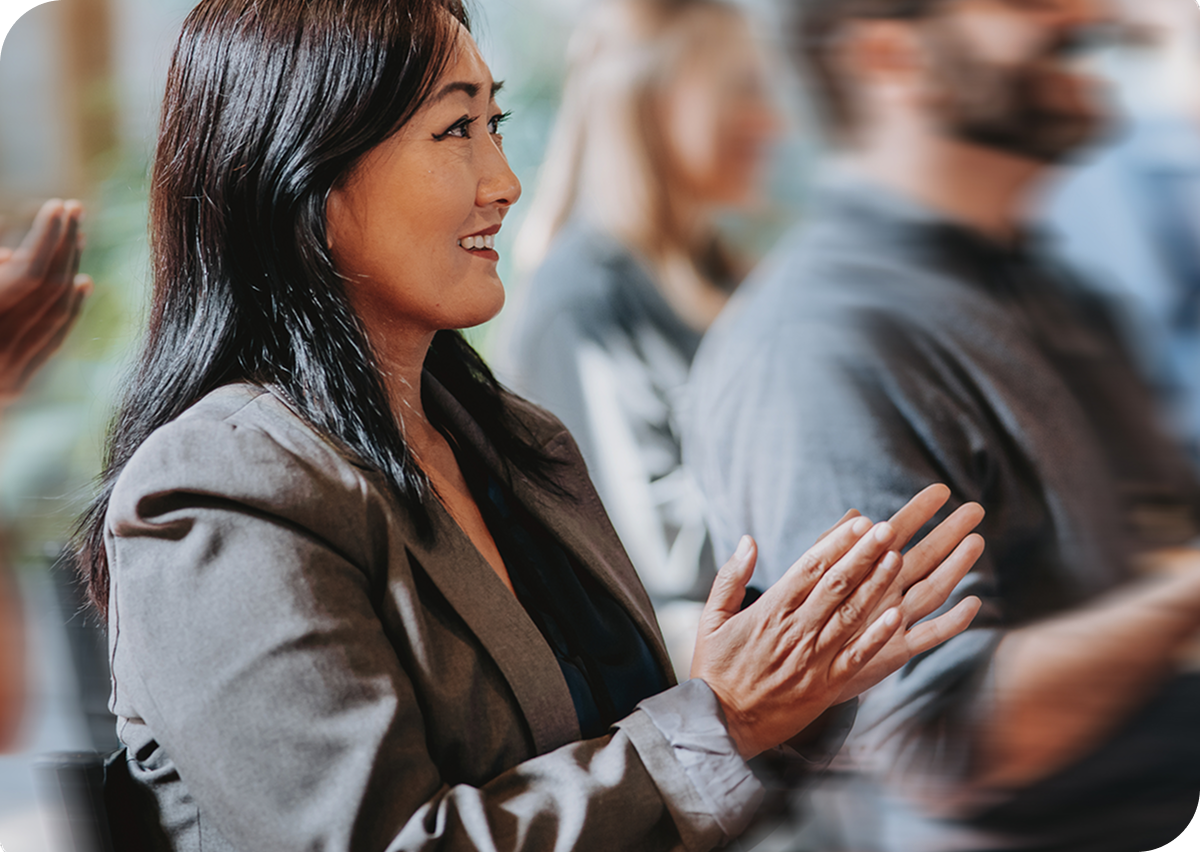 A woman clapping at a presentation