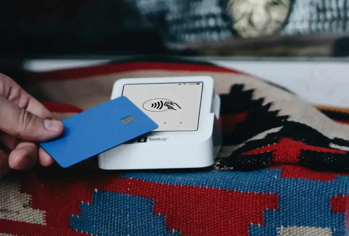 Person tapping a credit card to a payment system