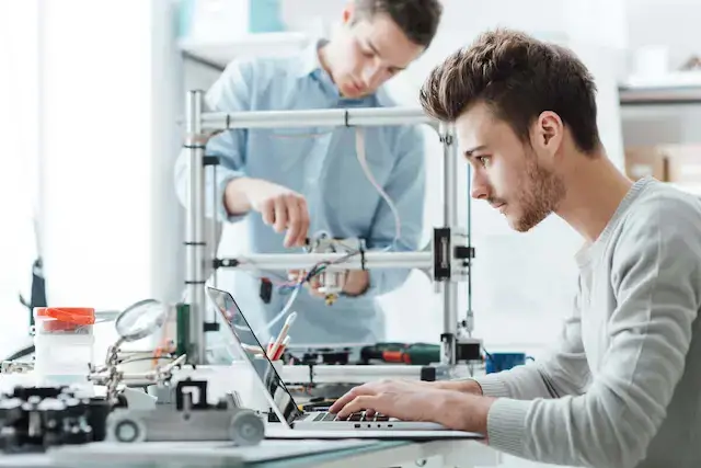 Two men in a robotics lab.