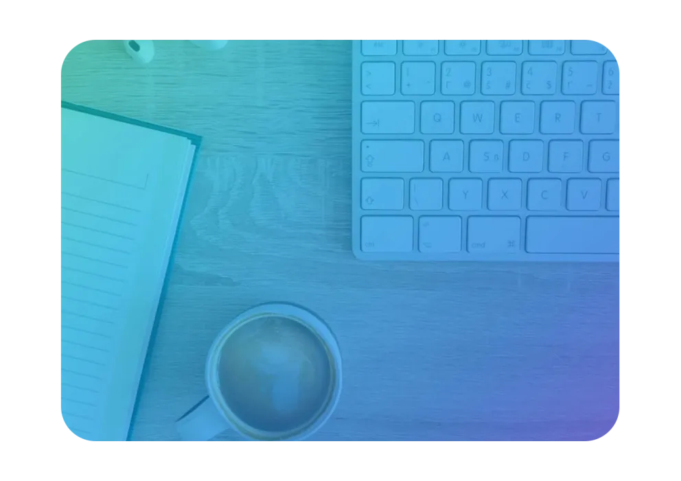 An image displaying a keyboard, a notepad, and a cup of coffee