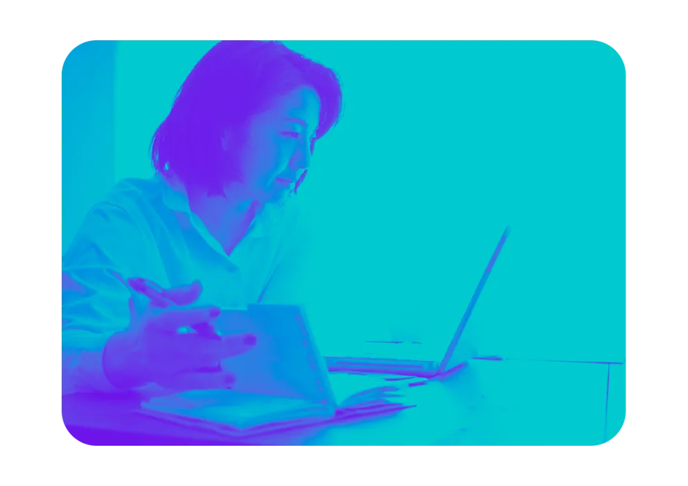 An image of a woman looking at a computer screen.