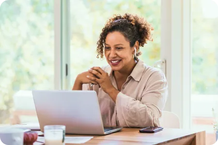 Woman smiling while working on her computer